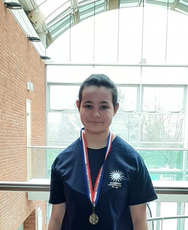 Amy wearing a medal after the Swimarathon